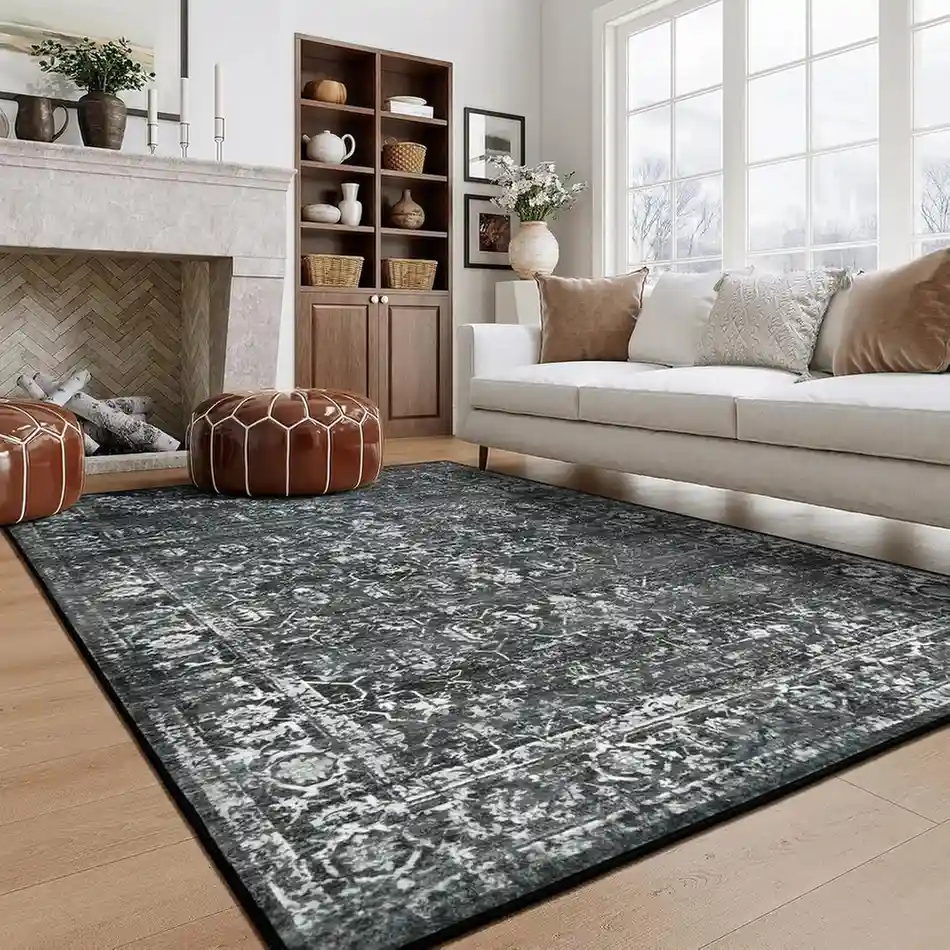 Gray and black distressed vintage area rug in living room with white sofa and fireplace