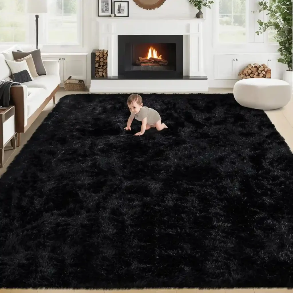 Baby crawling on large black shag area rug in bright modern living room with white fireplace