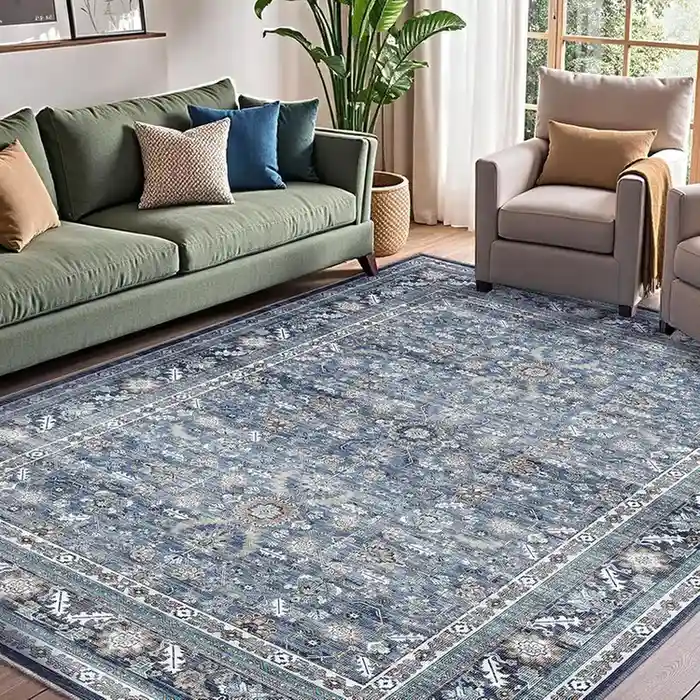 Blue gray traditional area rug with vintage Persian pattern in living room with green sofa