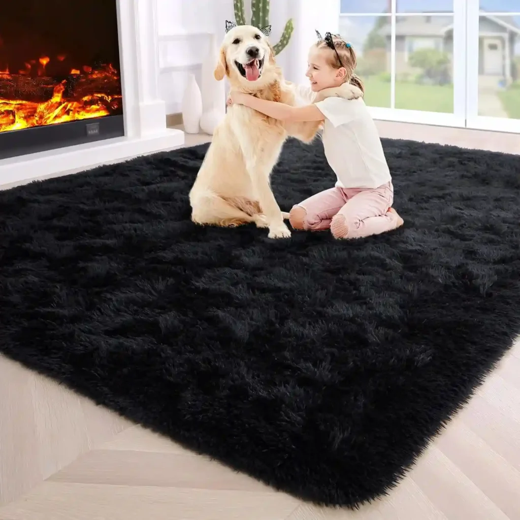 Happy child hugging golden retriever dog on large black shag area rug in cozy living room with fireplace