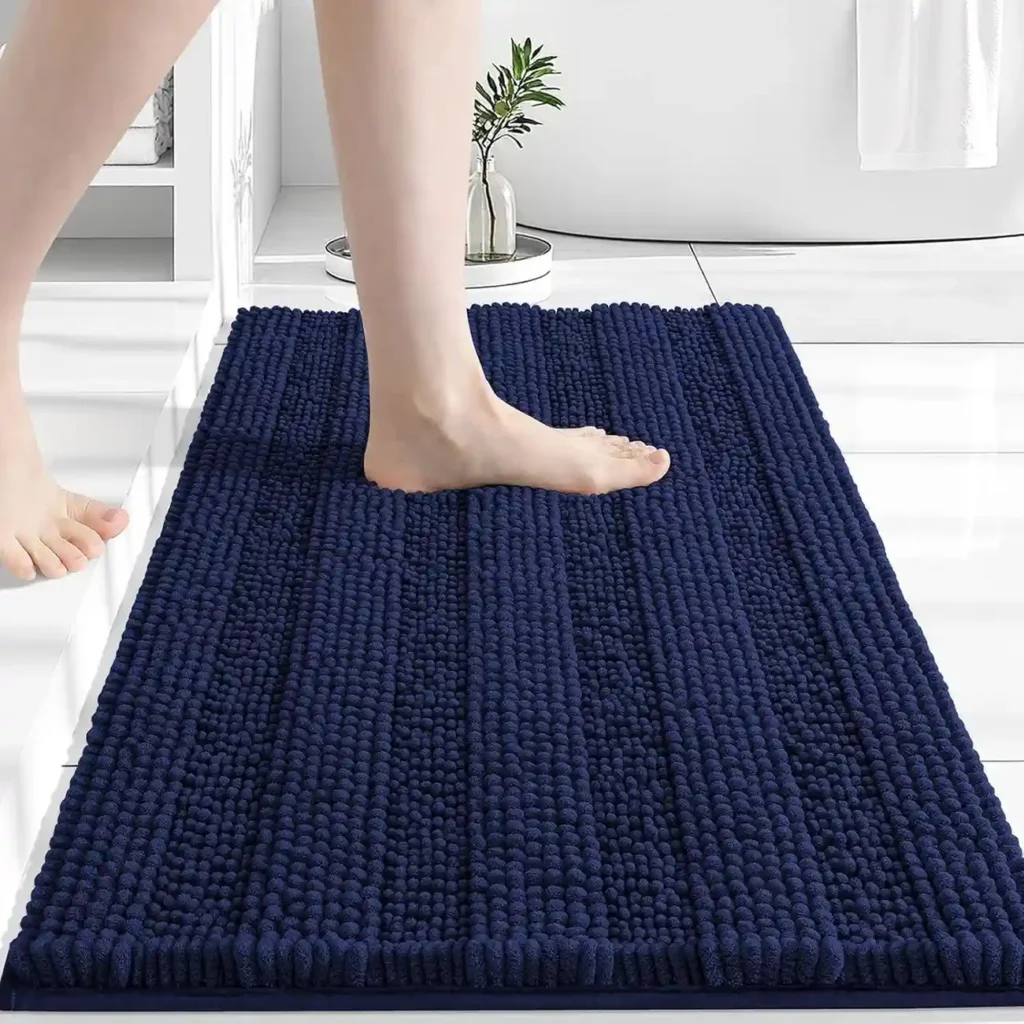 Navy blue chenille bath mat with soft finger texture in white bathroom