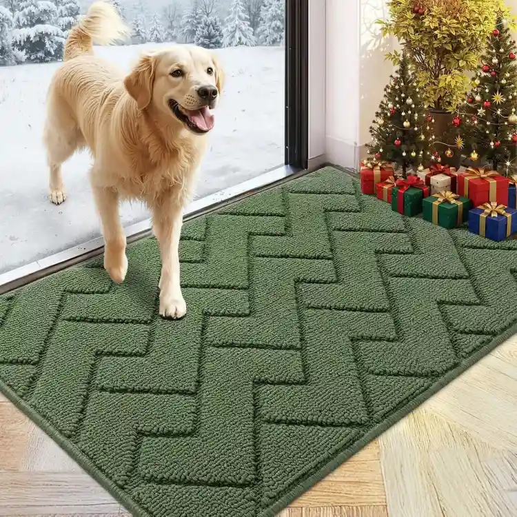 Olive green geometric patterned entryway doormat with raised zigzag texture, golden retriever standing near Christmas tree.
