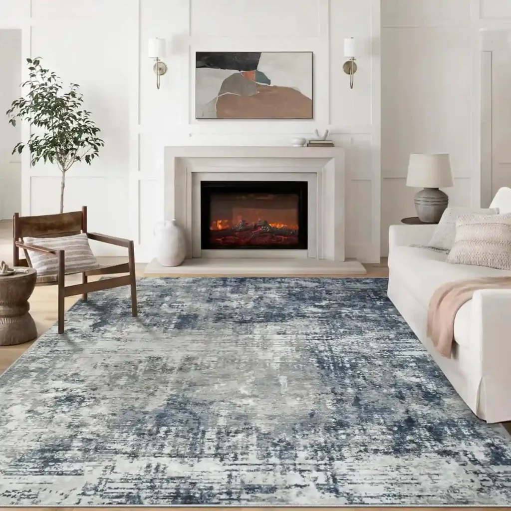 Blue gray distressed area rug in elegant white living room with fireplace and contemporary furniture