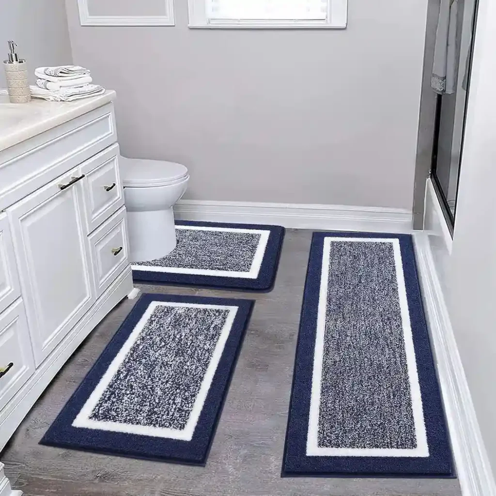 Navy blue and white 3-piece bathroom rug set with bordered design and speckled center pattern