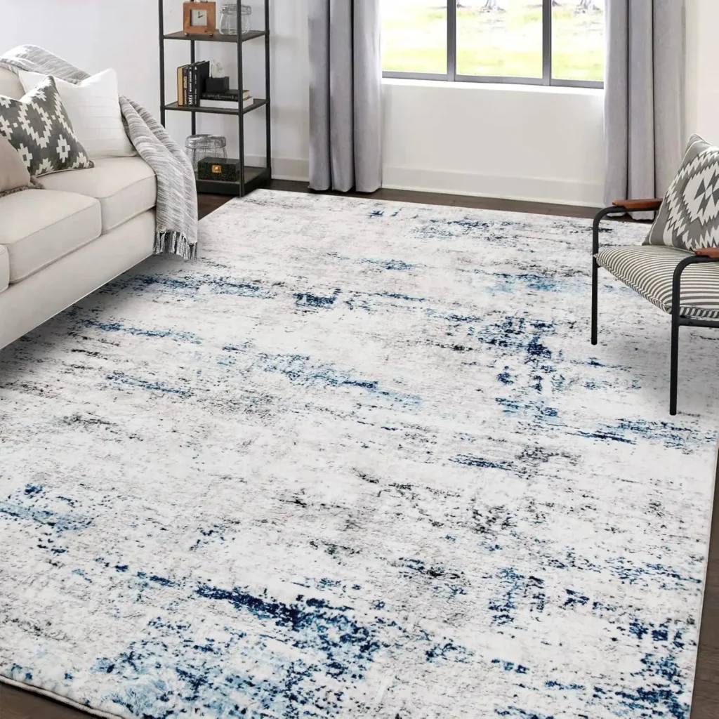 White and blue distressed abstract area rug in contemporary living room