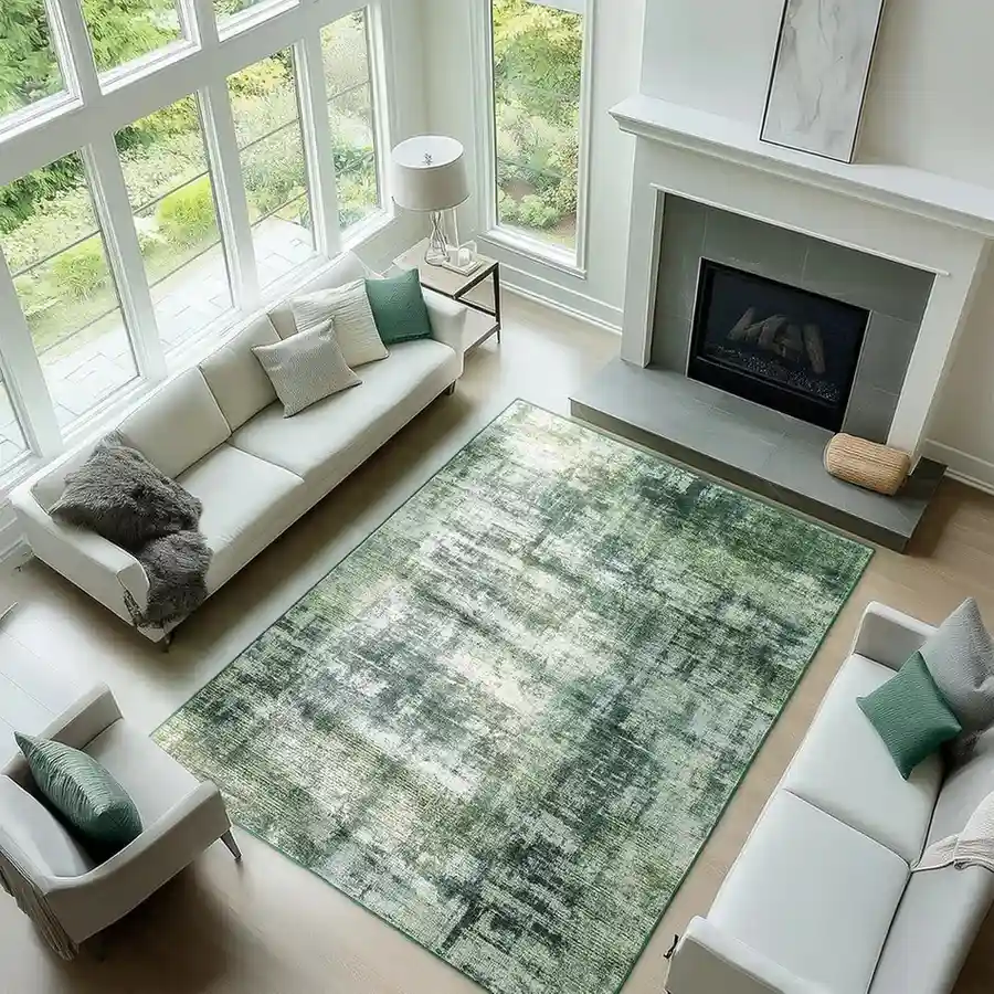Muted sage green distressed area rug with abstract weathered pattern, modern contemporary carpet in olive gray and cream tones for bright living room