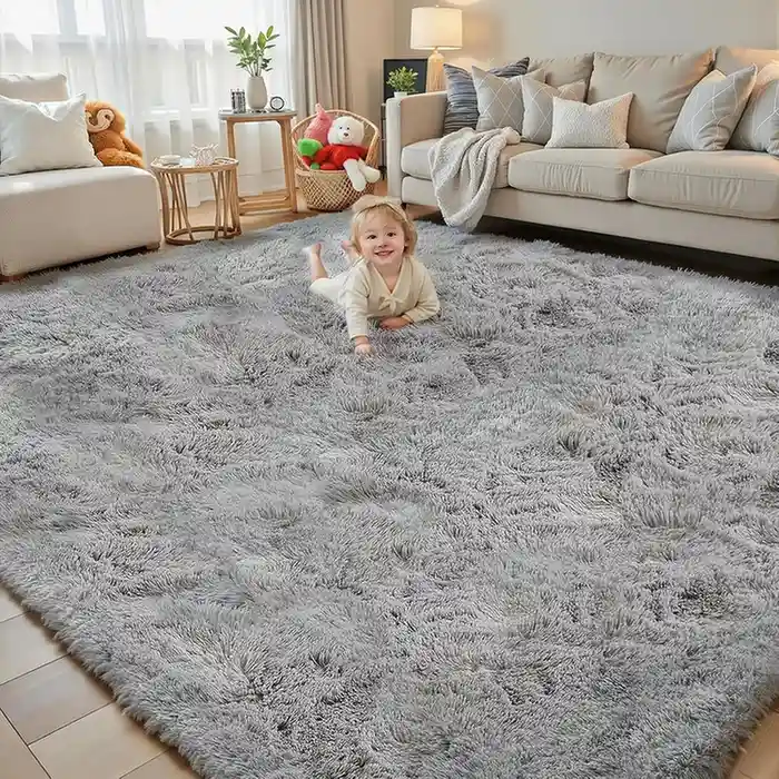 Light gray fluffy shag area rug in living room with baby