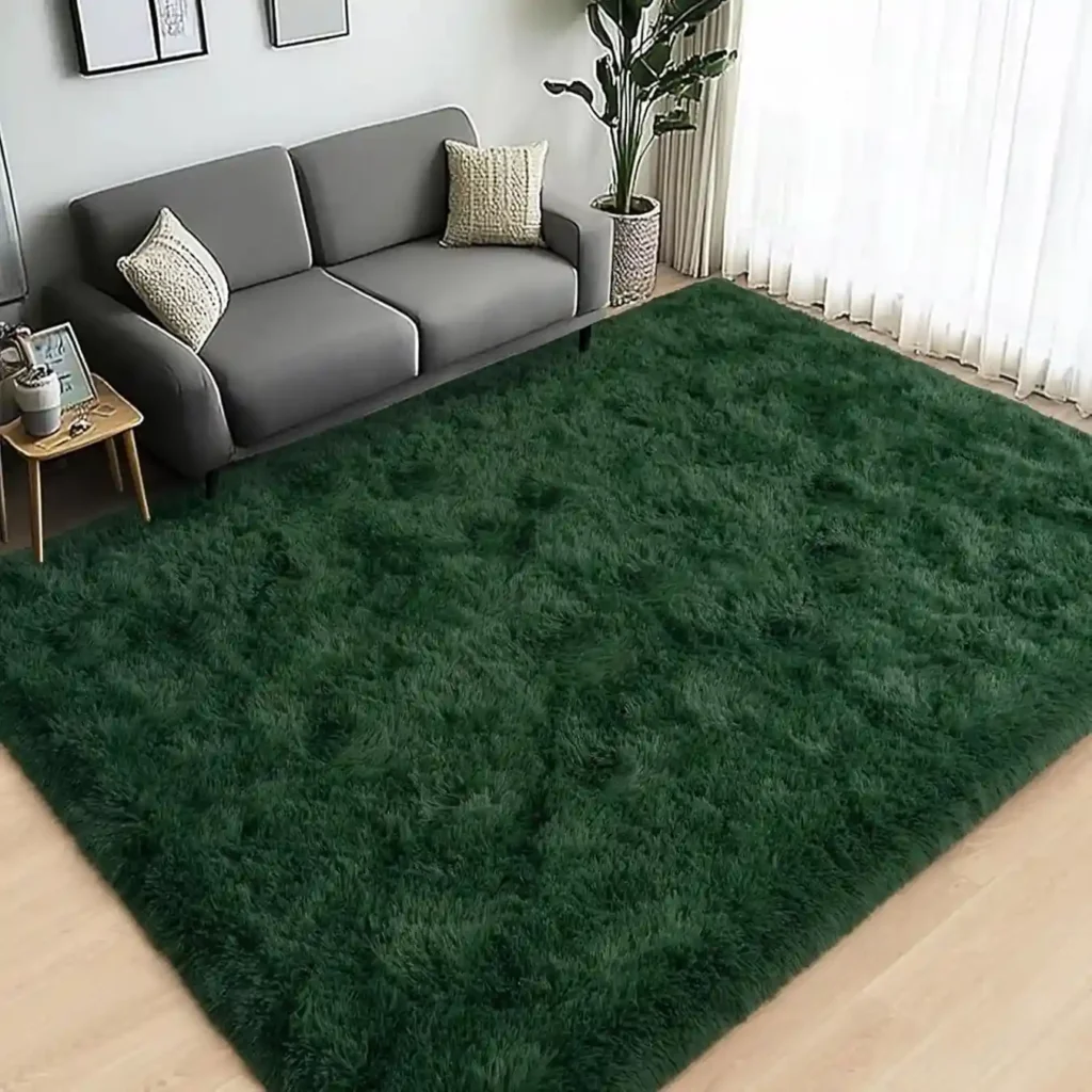Dark emerald green plush shag area rug in modern living room with gray sofa.