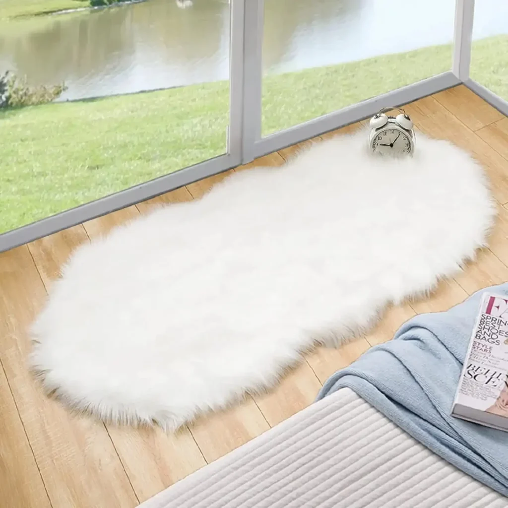 White fluffy faux fur rug on wooden floor near window with alarm clock on top.